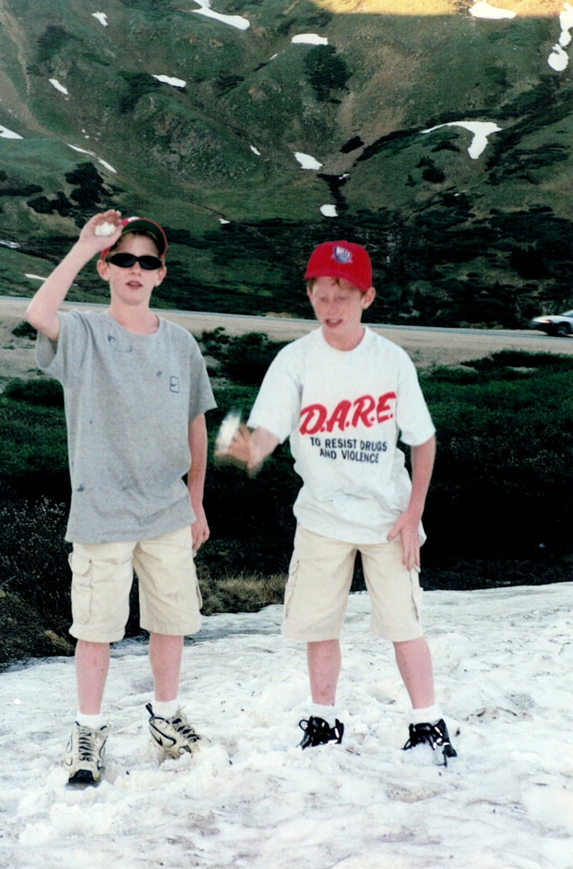 Matt Convente and Mike Convente standing in and playing with snow on July 4, 1999 on Pikes Peak, Colorado.